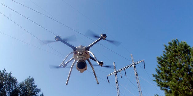 This June 22, 2015 photo shows a drone lifting off at a Georgia Power training complex during power line inspection demonstration in Lithonia, Ga. Power companies across the United States are testing whether drones as small as 10 pounds can spot trouble on transmission lines or inspect equipment deep inside hard-to-reach power plant boilers. (AP Photo/John Bazemore)