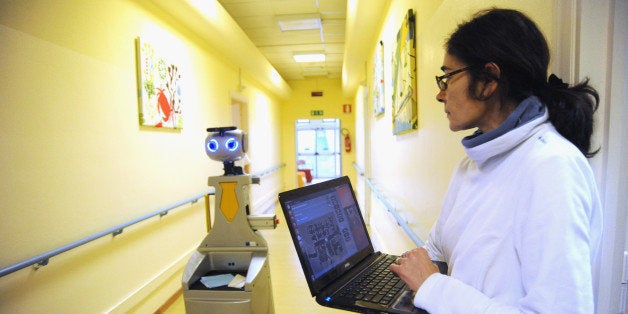 FLORENCE, ITALY - DECEMBER 18: A caregiver controls a robot of the project Robot-Era position on the map of a GUI (Graphical user Interface) at nursing residence San Lorenzo on December 19, 2015 in Florence, Italy. In the Residenza Sanitaria Assistenziale San Lorenzo ('nursing residence') a robot acts as a perfect caregiver or butler for the 20 elderly guests. Robots developed within the project Robot-Era coordinated by Robotics Institute of the Scuola Superiore Sant'Anna di Pisa are designed and programmed to perform functions in the house, outside and in the condominium. The EU supported project Robot-Era is the world's largest experiment ever done on service Robotics, involving 160 people in real-world environments with a duration of 4 years. The project is coordinated by the Scuola Superiore Sant'Anna di Pisa with tests inside the residence until December 21. (Photo by Laura Lezza/Getty Images)