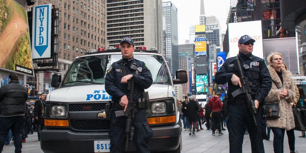 TIMES SQUARE, NEW YORK, NY, UNITED STATES - 2015/12/31: Heavily armed NYPD counterterrorism officers stand at post near the entrance to the restricted zone between 42nd and 43rd Streets. With a heightened degree of security due to the threat of a terrorist strike like those in Paris and San Bernadino, preparations for New York City's annual Times Square New Year's Eve celebration reflect the city's resolve to maintain public safety at such mass public gatherings. (Photo by Albin Lohr-Jones/Pacific Press/LightRocket via Getty Images)