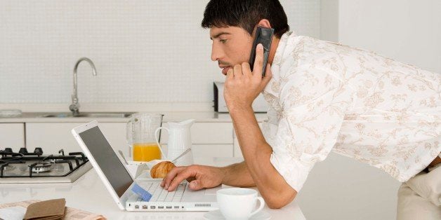 Man with laptop and cell phone