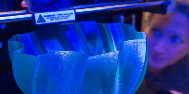 Alena Loeffler checks the printing process of a vase in a Witbox printer of the Spanish company BQ during the international f