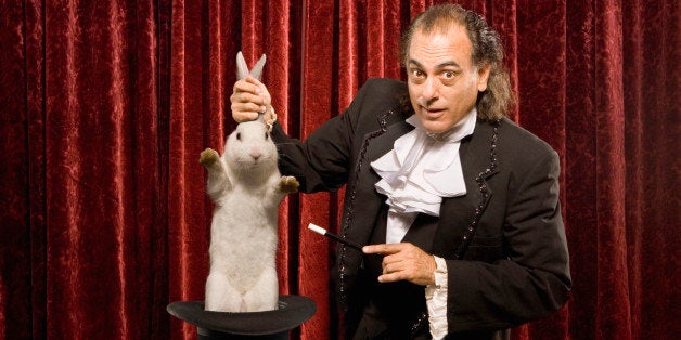 Magician pulling a rabbit out of a hat