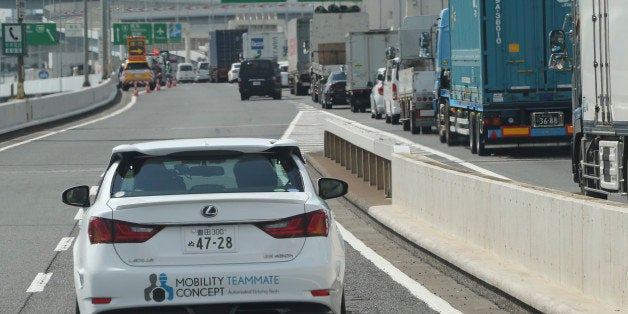 Toyota Motor Corp., automated driving test vehicle enters a highway on-ramp in Tokyo, Tuesday, Oct. 6, 2015. Toyota unveiled its vision for self-driving cars in a challenge to other automakers as well as industry newcomer Google Inc., promising to start selling such vehicles in Japan by 2020. Toyota Motor Corp. demonstrated on a regular Tokyo freeway Tuesday what it called the "mobility teammate concept," meaning the driver and the artificial intelligence in a sensor-packed car work together as a team. (AP Photo/Koji Sasahara)