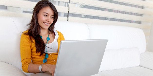 Beautiful woman sitting on the sofa with a laptop
