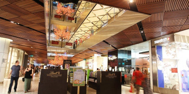 Shoppers walk past stores inside the Westfield Sydney shopping center, operated by Scentre Group, in Sydney, Australia, on Fr