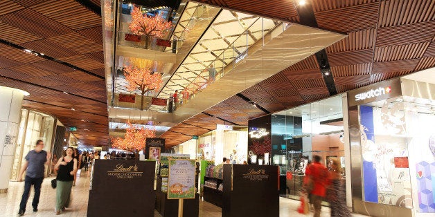 Shoppers walk past stores inside the Westfield Sydney shopping center, operated by Scentre Group, in Sydney, Australia, on Friday, Feb. 19, 2016. Scentre Group, the Australia-focused counterpart of Westfield Corp., is scheduled to report full-year results on Feb. 23. Photographer: Brendon Thorne/Bloomberg via Getty Images