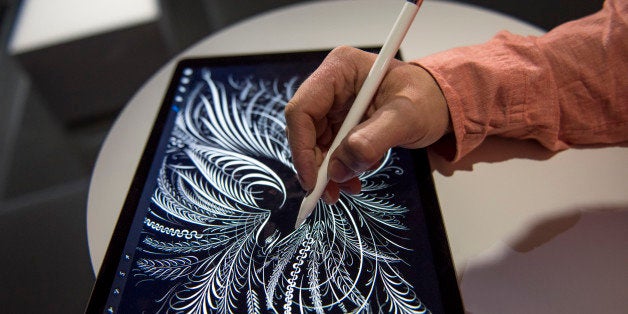 An exhibitor demonstrates the new Apple Pencil with the Apple Inc. iPad Pro tablet computer after a product announcement in S