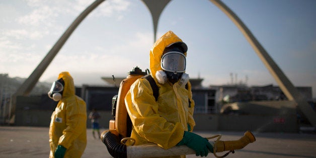 FILE - In this Tuesday, Jan. 26, 2016 file photo, a health workers stands in the Sambadrome spraying insecticide to combat th