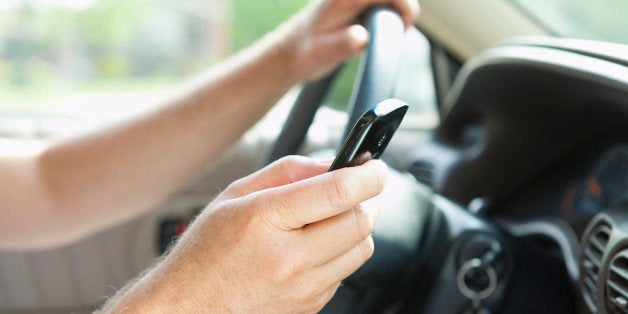 USA, Illinois, Metamora, close-up of man sitting behind steering wheel and text messaging