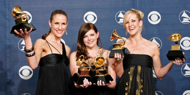 The Dixie Chicks (L-R) Emily Robison, Natalie Maines and Martie Maguire pose with their Grammys at the 49th Annual Grammy Awards in Los Angeles February 11, 2007. The group won the Record of The Year, Song of the Year and Best Country Performance by a Duo or Group with Vocal for "Not Ready to Make Nice"; and Best Country Album and Album of the Year for "Taking The Long Way". REUTERS/Mike Blake (UNITED STATES)