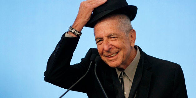 Musician Leonard Cohen tips his hat to the audience as he accepts the 2012 Awards for Song Lyrics of Literary Excellence, which was awarded to both he and Chuck Berry at the John F. Kennedy Presidential Library and Museum, in Boston, Massachusetts, U.S. on February 26, 2012. REUTERS/Jessica Rinaldi/File Photo