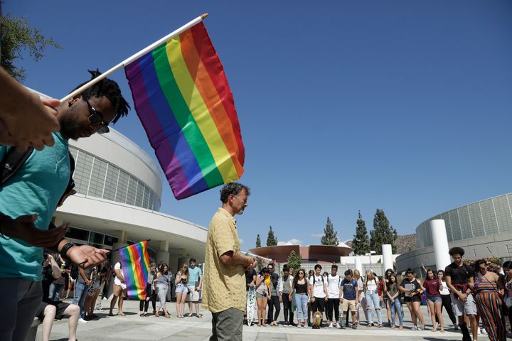 Rob Muthiah, a professor of practical theology in the seminary, offers a prayer at a rally at Azusa Pacific University to protest the school's reinstatement of a ban on same-sex relationships.