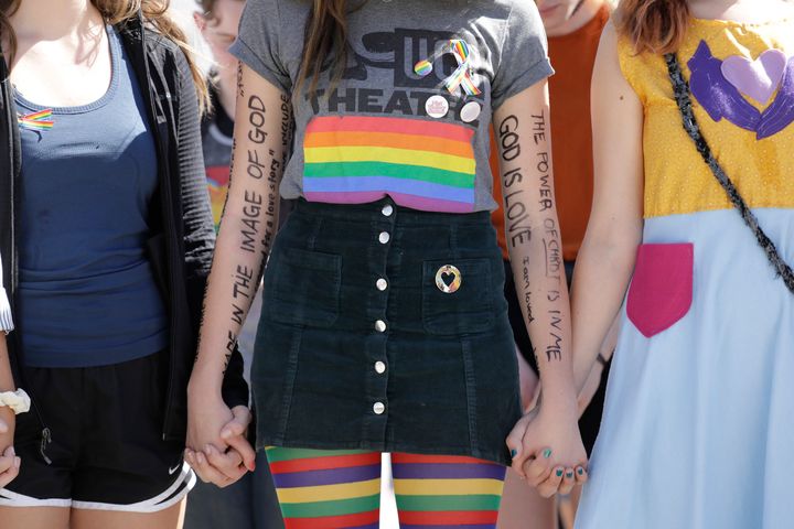 Messages of acceptance written on the arms of senior Cayla Hailwood during a community rally at Azusa Pacific University to protests the school's policy reversal.