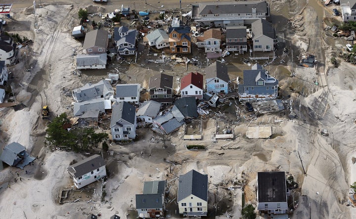 SEASIDE HEIGHTS, NJ - OCTOBER 31: Homes wrecked by Superstorm Sandy sit amongst sand washed ashore on October 31, 2012 in Seaside Heights, New Jersey. At least 50 people were reportedly killed in the U.S. by Sandy with New Jersey suffering massive damage and power outages. (Photo by Mario Tama/Getty Images)