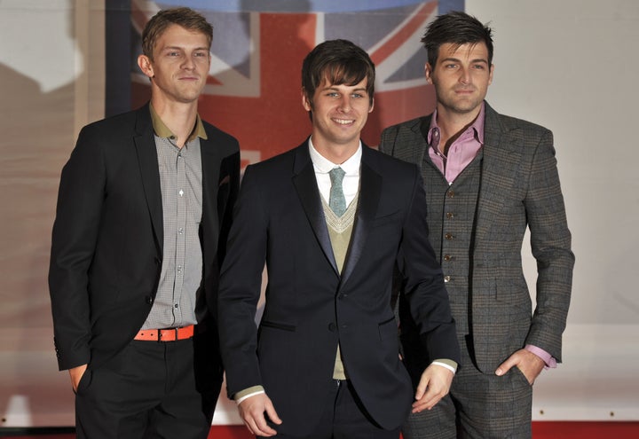 (L-R) Mark Pontius, Mark Foster and Cubbie Fink of band Foster The People pose on the red carpet arriving at the BRIT Awards 2012 in London on February 21, 2012. AFP PHOTO / BEN STANSALL (Photo credit should read BEN STANSALL/AFP/Getty Images)