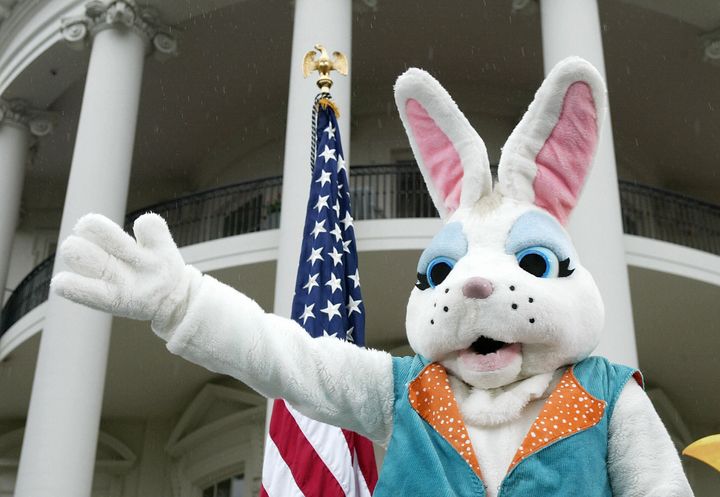 WASHINGTON, UNITED STATES: The Easter Bunny waves prior to the start of the annual Easter Egg Roll on the South Lawn that attracted several hundred children in the rain at the White House 12 April 2004 in Washington, DC. The egg rolling tradition began in 1878, when President Rutherford B. Hayes officially opened the White House grounds to local children for egg rolling on Easter Monday. Successive Presidents continued the tradition, and the event has been held on the South Lawn ever since. AFP Photo/Stephen JAFFE (Photo credit should read STEPHEN JAFFE/AFP/Getty Images)