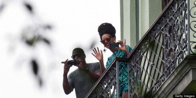 US singer Beyonce is seen in a balcony of the Saratoga Hotel in Havana next to her husband Jay Z, on April 5, 2013. Pop diva Beyonce and her rapper husband Jay-Z on Thursday created a stir as they toured the streets of Old Havana, with hundreds of Cubans turning out to catch a glimpse of the US power couple. AFP PHOTO/STR (Photo credit should read STR/AFP/Getty Images)