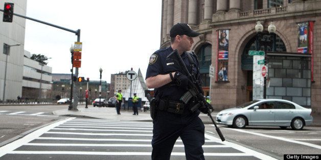 BOSTON, MA - APRIL 19: A swat team member scouts the perimeter of South Station on April 19, 2013 in Boston, Massachusetts. South Station was shut down and heavily guarded with police in response to the early morning shootings in Cambridge and Watertown, Massachusetts. After a car chase and shoot out with police, one suspect in the Boston Marathon bombing, Tamerlan Tsarnaev, 26, was shot and killed by police early morning April 19, and a manhunt is underway for his brother and second suspect, 19-year-old suspect Dzhokhar A. Tsarnaev. The two men, reportedly Chechen origin, are suspects in the bombings at the Boston Marathon on April 15, that killed three people and wounded at least 170. (Photo by Kayana Szymczak/Getty Images)