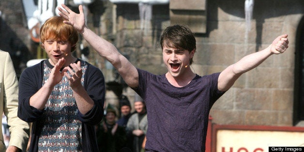 Harry Potter films star Daniel Radcliffe, right, cheers with the crowd, with co-star Rupert Grint during the official grand opening at the Wizarding World of Harry Potter at Universal Orlando, Friday, June 18, 2010. (Photo by Joe Burbank/Orlando Sentinel/MCT via Getty Images)