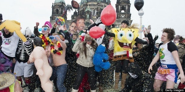 Participants in a flashmob dance an improvised version of the Harlem Shake as they throw confetti in the air in front of the Berlin cathedral February 20, 2013. The flashmob was called in an effort to gather as many people as possible and perform the Harlem Shake in sub-zero temperatures. AFP PHOTO / JOHN MACDOUGALL (Photo credit should read JOHN MACDOUGALL/AFP/Getty Images)