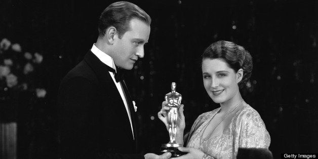 31st October 1930: Canadian star Norma Shearer (1902 - 1983) receives a Best Actress Oscar from Conrad Nagel (1897 - 1970), for her role in 'The Divorcee'. The two co-starred as lovers in the film, which was directed by Robert Z Leonard. (Photo by John Kobal Foundation/Getty Images)