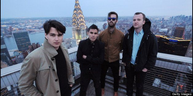 Vampire Weekend pose for a group portrait session on the roof of the on the MetLife Building in New York on 29th April 2013. Left to right: Ezra Koenig, Rostam Batmanglij, Chris Tomson, Chris Baio. (Photo by David Corio/Redferns)