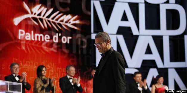 French-Tunisian director Abdellatif Kechiche arrives on stage on May 26, 2013 after he was awarded with the Palme d'Or for the film 'Blue is the Warmest Colour' during the closing ceremony of the 66th Cannes film festival in Cannes. AFP PHOTO / VALERY HACHE (Photo credit should read VALERY HACHE/AFP/Getty Images)