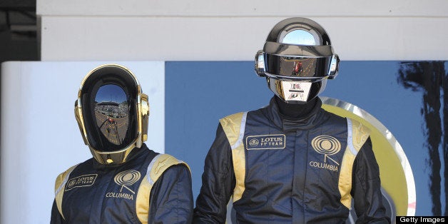 French Daft Punk band members pose in the pits at the Monaco Formula One Grand Prix at the Circuit de Monaco in Monte Carlo on May 26, 2013. AFP PHOTO / BORIS HORVAT (Photo credit should read BORIS HORVAT/AFP/Getty Images)