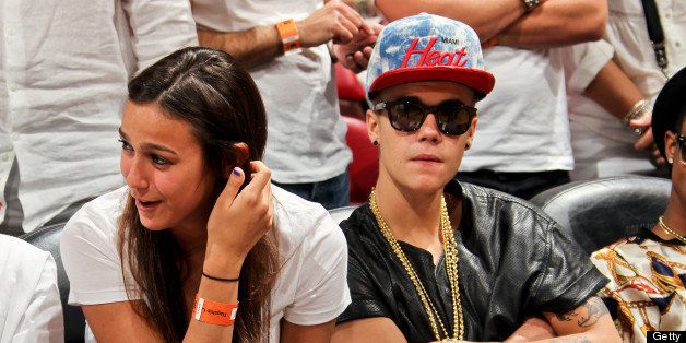 MIAMI, FL - JUNE 3: Recording artist Justin Bieber, right, looks on as the Indiana Pacers play the Miami Heat in Game Seven of the Eastern Conference Finals during the 2013 NBA Playoffs on June 3, 2013 at American Airlines Arena in Miami, Florida. NOTE TO USER: User expressly acknowledges and agrees that, by downloading and/or using this photograph, user is consenting to the terms and conditions of the Getty Images License Agreement. Mandatory copyright notice: Copyright NBAE 2013 (Photo by Issac Baldizon/NBAE via Getty Images)