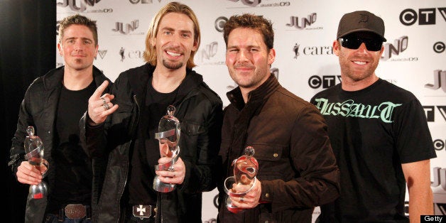 VANCOUVER, BC - MARCH 29: 2009 Juno Award Winners for Juno Fan Choice, Album of the Year 'Dark Horse' and Group of the Year, Daniel Adair, Chad Kroeger, Ryan Peake and Mike Kroeger of Nickelback pose with their award in the press room at the 2009 Juno Awards at General Motors Place on March 29, 2009 in Vancouver, British Columbia, Canada. (Photo by George Pimentel/WireImage)