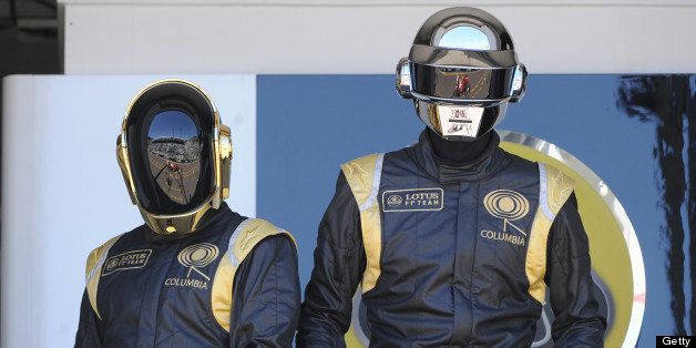 French Daft Punk band members pose in the pits at the Monaco Formula One Grand Prix at the Circuit de Monaco in Monte Carlo on May 26, 2013. AFP PHOTO / BORIS HORVAT (Photo credit should read BORIS HORVAT/AFP/Getty Images)