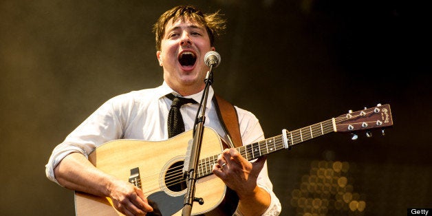 LONDON, UNITED KINGDOM - JULY 06: Marcus Mumford of Mumford & Sons performs at their biggest headline show to date during the Summer Stampede tour at Olympic Park on July 6, 2013 in London, England. (Photo by Ollie Millington/Getty Images)