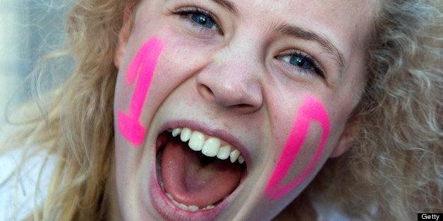 A fan of British-Irish boy band One Direction screams as she waits for a glimpse of her idols ahead of a concert in Wellingto