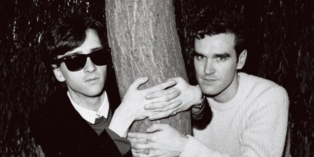 LONDON - 1st JANUARY: Johnny Marr (left) and Morrissey from The Smiths posed with their arms around a tree trunk in London in
