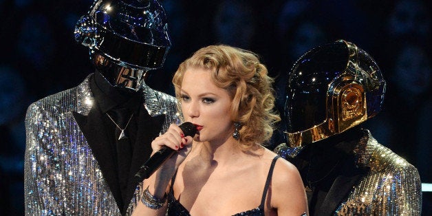 NEW YORK, NY - AUGUST 25: Musician Taylor Swift accepts an award from Daft Punk during the 2013 MTV Video Music Awards at the Barclays Center on August 25, 2013 in the Brooklyn borough of New York City. (Photo by Theo Wargo/WireImage)