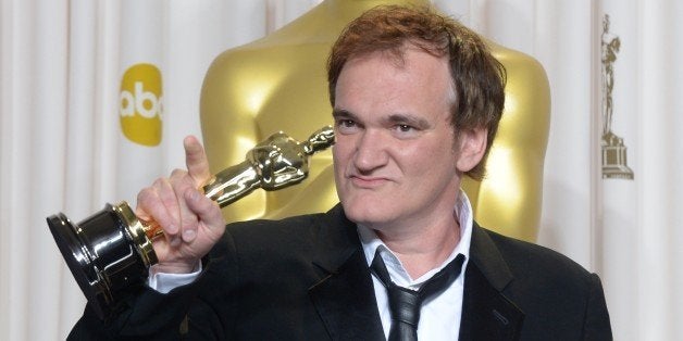 Quentin Tarantino holds the trophy for Best Original Screenplay in the press room during the 85th Annual Academy Awards on Fe
