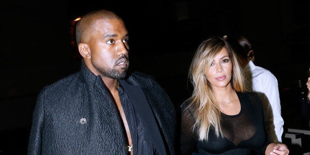 PARIS, FRANCE - SEPTEMBER 29: Kim Kardashian and Kanye West arriving at Givenchy show as part of the Paris Fashion Week Womenswear Spring/Summer 2014, held at 'la Halle Freyssinet' on September 29, 2013 in Paris, France. (Photo by Bertrand Rindoff Petroff/Getty Images)