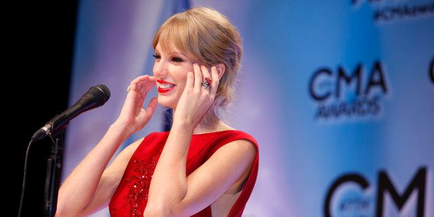 NASHVILLE, TN - NOVEMBER 06: Taylor Swift receives an award at the 47th annual CMA Awards at the Bridgestone Arena on November 6, 2013 in Nashville, Tennessee. (Photo by Sara Kauss/WireImage)