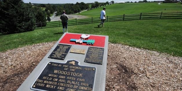 TO GO WITH AFP STORIES 'US-MUSIC-SOCIETY-HISTORY-WOODSTOCK' A monument at the site of the Woodstock Music and Arts Fair, next to the Bethel Woods Center for the Arts is seen on August 3, 2009 in Bethel, New York. This year marks the 40th anniversary of the iconic concert held August 15-18, 1969 on the farm of local resident Max Yasgur. The original stage was on the bare ground beyond the fence where more than 30 acts played to an estimated 450,000 people, who occupied the grassy area in the background. AFP PHOTO/Stan Honda (Photo credit should read STAN HONDA/AFP/Getty Images)