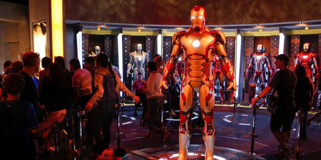 Guests tour suits of Marvel's Iron Man armor in the Iron Man Tech Presented by Stark Industries exhibit at Walt Disney Co.'s Disneyland Park, part of the Disneyland Resort, in Anaheim, California, U.S., on Wednesday, Nov. 6, 2013. The Walt Disney Co. is scheduled to release earnings figures on Nov. 7. Photographer: Patrick Fallon/Bloomberg via Getty Images