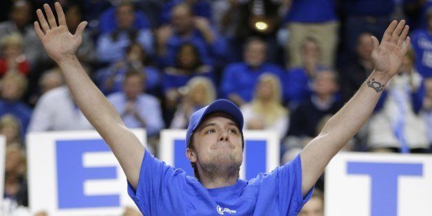 'Hunger Games' star Josh Hutcherson makes the Y for Kentucky as the Wildcats play host to Louisville at Rupp Arena in Lexington, Ky., on Saturday, Dec. 28, 2013. Kentucky won, 73-66. (Mark Cornelison/Lexington Herald-Leader/MCT via Getty Images)