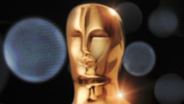 An Oscar stands on the podium in front of a projection of an Oscar before the start of the 84th Academy Awards Nominations An