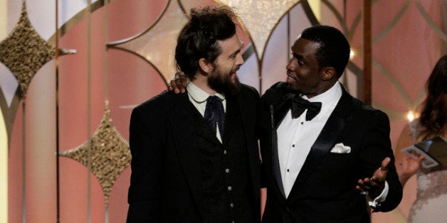 BEVERLY HILLS, CA - JANUARY 12: In this handout photo provided by NBCUniversal, Sean Diddy Combs presents Alex Ebert with the award for Best Original Score - Motion Picture for 'All is Lost' during the 71st Annual Golden Globe Award at The Beverly Hilton Hotel on January 12, 2014 in Beverly Hills, California. (Photo by Paul Drinkwater/NBCUniversal via Getty Images)