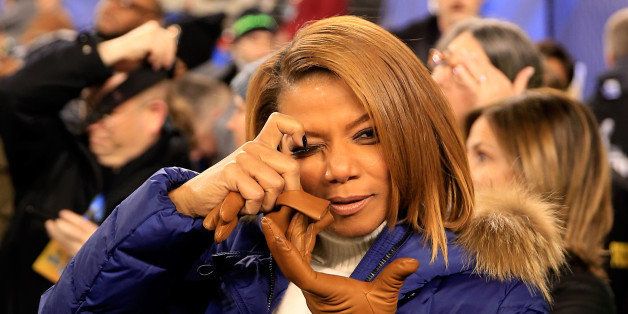 EAST RUTHERFORD, NJ - FEBRUARY 02: Queen Latifah pretends to take a photo before the Seattle Seahawks take on the Denver Broncos during Super Bowl XLVIII at MetLife Stadium on February 2, 2014 in East Rutherford, New Jersey. (Photo by Rob Carr/Getty Images)