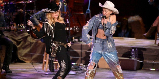 HOLLYWOOD, CA - JANUARY 28: Recording artists Madonna (L) and Miley Cyrus perform onstage during Miley Cyrus: MTV Unplugged at Sunset Gower Studios on January 28, 2014 in Hollywood, California. (Photo by Christopher Polk/Getty Images for MTV)