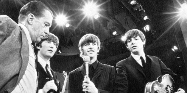 American TV host Ed Sullivan, left, talks with three members of the British pop group The Beatles during a rehearsal for their appearance on his TV show, in New York, Feb. 8, 1964. From left, Sullivan, John Lennon, Ringo Starr and Paul McCartney. George Harrison, the fourth member of the group missed the rehearsal due to illness. (AP Photo)