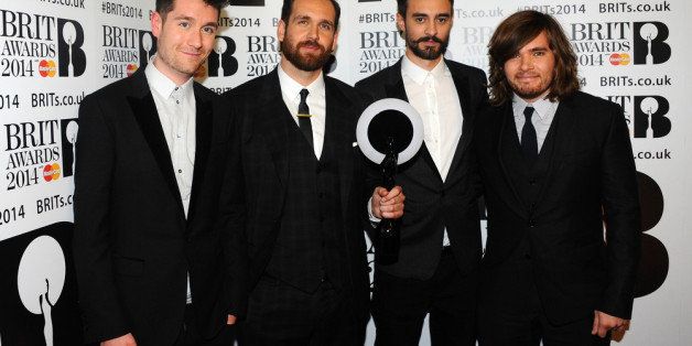 LONDON, ENGLAND - FEBRUARY 19: Dan Smith, Chris 'Woody' Wood, Kyle Simmons and Will Farquarson of Bastille, winner of the British Breakthrough Act award, pose in the winners room at The BRIT Awards 2014 at 02 Arena on February 19, 2014 in London, England. (Photo by Anthony Harvey/Getty Images)
