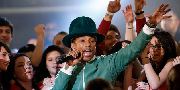 US singer Pharrell Williams sings during the 'Le Grand Journal' TV show at the headquarters of the French television channel Canal Plus in Paris, on February 24, 2014. AFP PHOTO / THOMAS SAMSON (Photo credit should read THOMAS SAMSON/AFP/Getty Images)