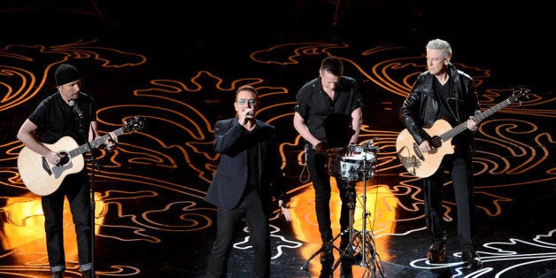 HOLLYWOOD, CA - MARCH 02: (L-R) Musicians The Edge, Bono, Larry Mullen Jr., and Adam Clayton of U2 perform onstage during the Oscars at the Dolby Theatre on March 2, 2014 in Hollywood, California. (Photo by Kevin Winter/Getty Images)