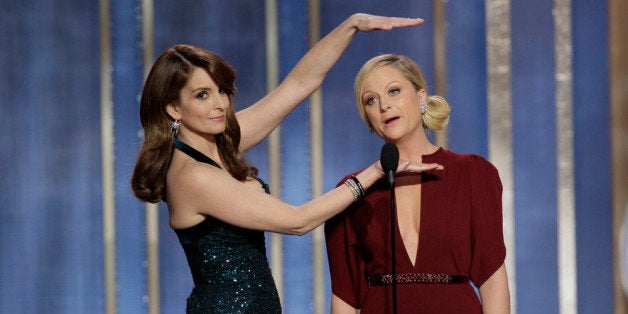 BEVERLY HILLS, CA - JANUARY 13: In this handout photo provided by NBCUniversal, L to R Tina Fey and Amy Poehler host the 70th Annual Golden Globe Awards at the Beverly Hilton Hotel International Ballroom on January 13, 2013 in Beverly Hills, California. (Photo by Paul Drinkwater/NBCUniversal via Getty Images)